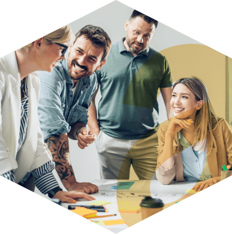 Photo of a cheerful team of professionals collaborating at an office, with the aKUBE logo icon overlayed in the foreground.