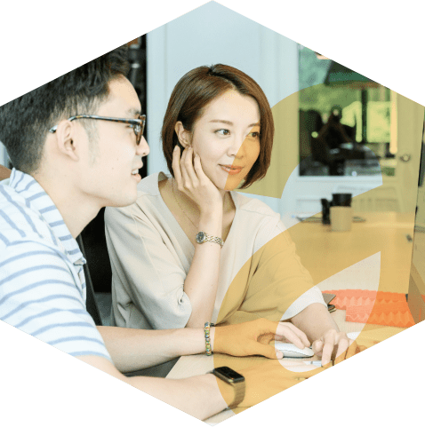 Two professionals working collaboratively in an office, with the aKUBE logo icon overlayed in the foreground.