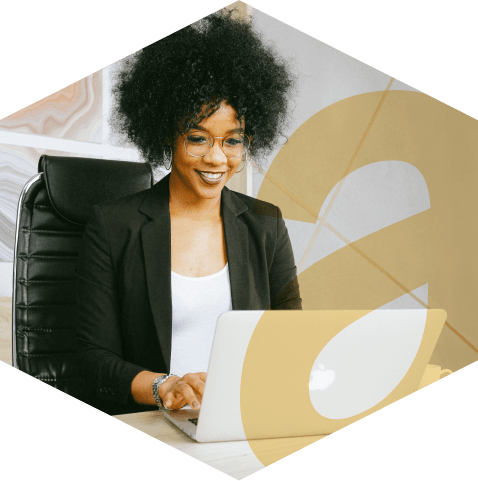 A professional working intently on her laptop in an office, with the aKUBE logo icon overlayed in the foreground.